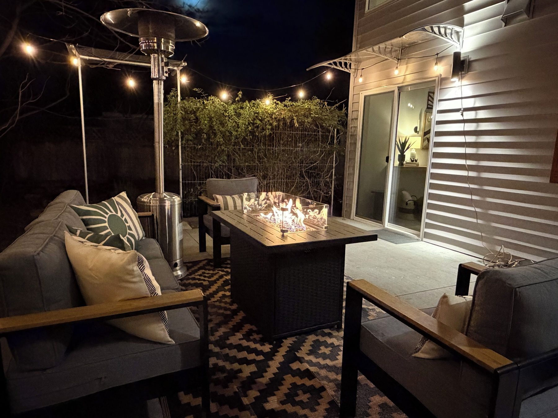 Evening patio with string lights and fire pit